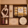 Sweet Memories Rakhi Hamper featuring a premium decor figurine, personalized message card, rakhi, roli-chawal kit, premium fridge magnet and customer's choice of Ferrero Rocher or Lindt chocolates