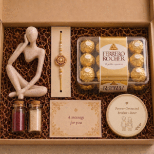 Sweet Memories Rakhi Hamper featuring a premium decor figurine, personalized message card, rakhi, roli-chawal kit, premium fridge magnet and customer's choice of Ferrero Rocher or Lindt chocolates