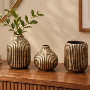 Styled antique ceramic vase set on an entryway credenza beside a mirror and warm room lighting