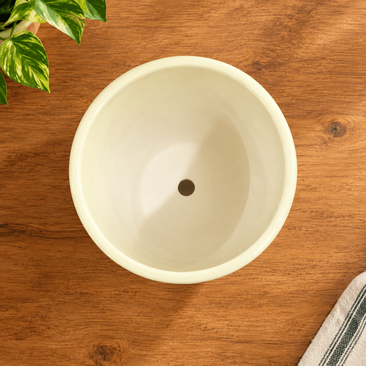 Top view of decorative ceramic flower pot showing drainage hole