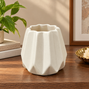Cream ceramic decorative vase with a faceted body and scalloped rim