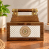 Brown and gold organizer with handle and decorative mandala front panel on a wooden tabletop