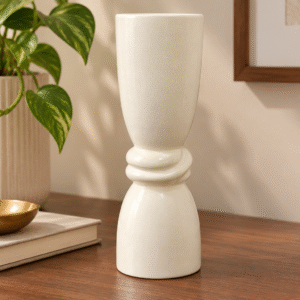 Ivory ceramic decorative vase with sculptural ring design on a white background