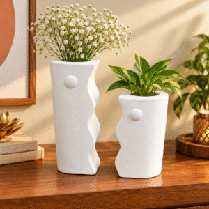 Two white decorative vases in different heights featuring a contemporary wavy silhouette and matte finish