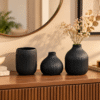 Black ribbed ceramic vase set of 3 displayed on a console table