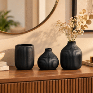 Black ribbed ceramic vase set of 3 displayed on a console table