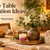 Festive table decoration ideas for Indian homes with a floral vase, rose petal candle, decorative napkin and cutlery holder, and elegant gold table accents.