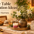 Festive table decoration ideas for Indian homes with a floral vase, rose petal candle, decorative napkin and cutlery holder, and elegant gold table accents.